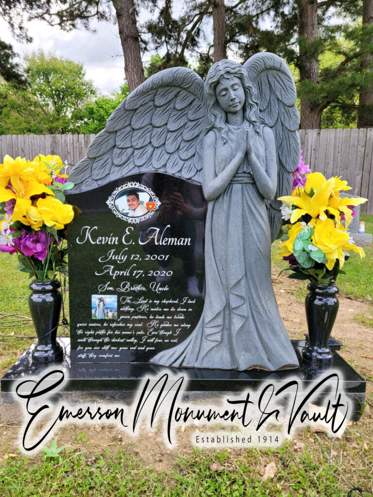 This fully carved, custom angel memorial featuring enameled steel photos, was installed in the cemetery. 